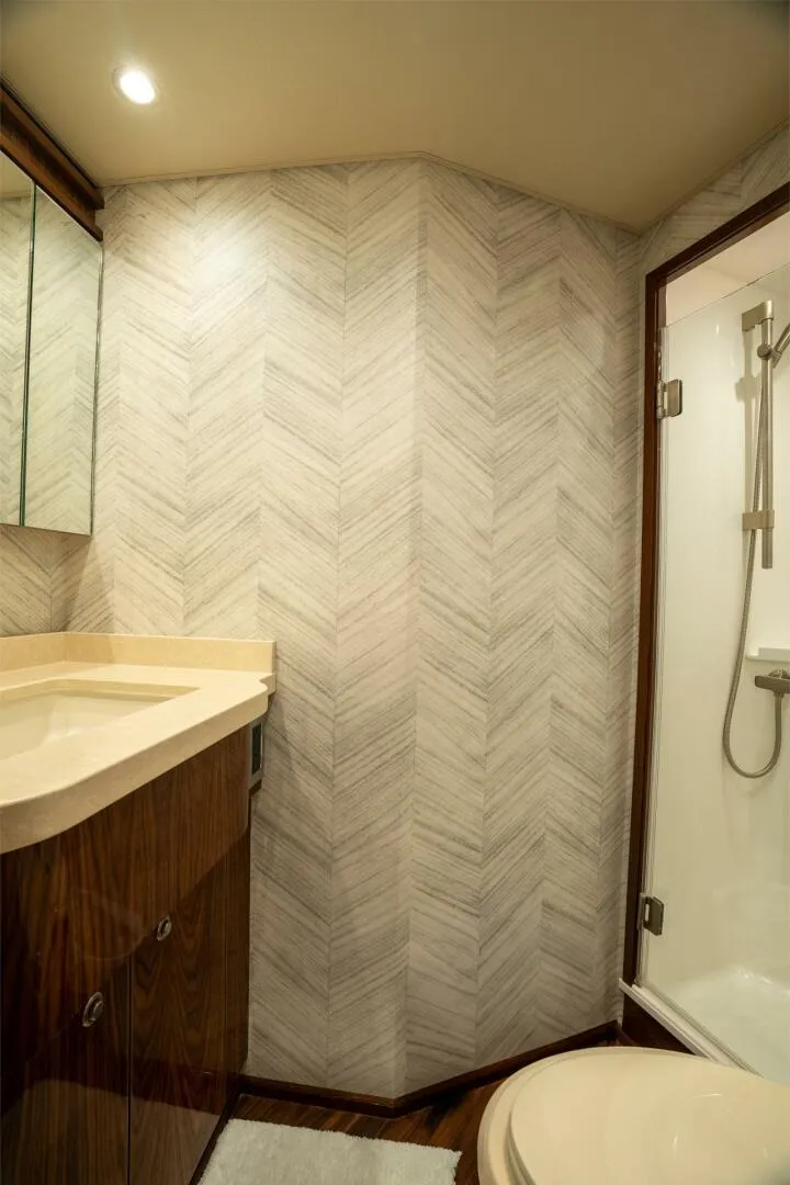 Slide: The Image of Bathroom interior of 2021 Viking 68 Enclosed Bridge Convertible yacht, featuring modern design. - 24