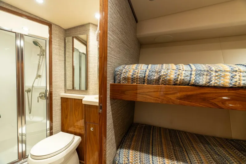 Slide: The Image of Interior of 2021 Viking 68 Enclosed Bridge Convertible with bunk beds and bathroom. - 26