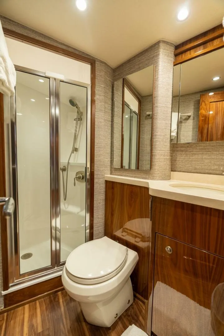 Slide: The Image of Luxurious bathroom in 2021 Viking 68 Enclosed Bridge Convertible yacht with modern fixtures. - 27