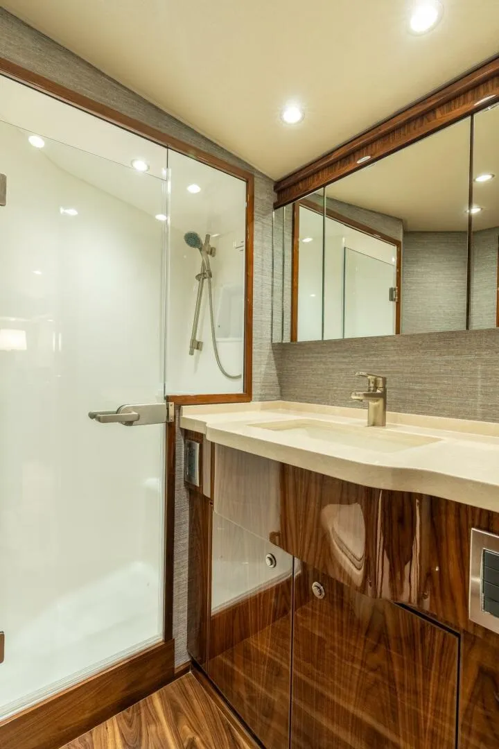 Slide: The Image of Luxurious bathroom in 2021 Viking 68 Enclosed Bridge Convertible yacht with modern fixtures. - 29