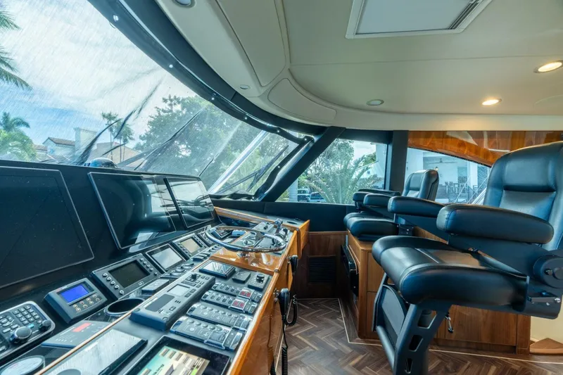 Slide: The Image of Interior of 2021 Viking 68 Enclosed Bridge Convertible yacht with advanced navigation controls. - 3