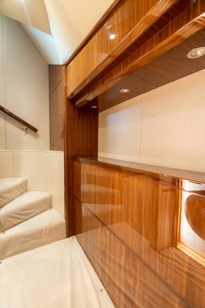 Slide: The Image of Interior of 2021 Viking 68 Enclosed Bridge Convertible yacht, featuring elegant wood paneling. - 31