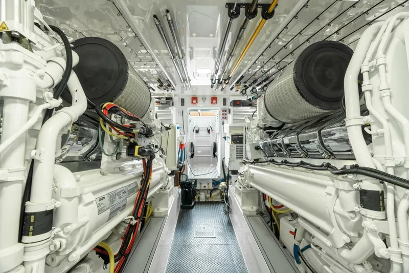 Slide: The Image of Engine room of 2021 Viking 68 Enclosed Bridge Convertible yacht, showcasing advanced machinery. - 35