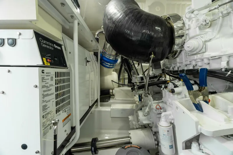 Slide: The Image of Engine room of 2021 Viking 68 Enclosed Bridge Convertible yacht, featuring Cummins Onan generator. - 37