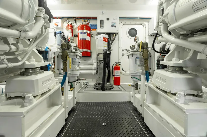 Slide: The Image of Engine room of 2021 Viking 68 Enclosed Bridge Convertible, featuring advanced machinery and safety equipment. - 39