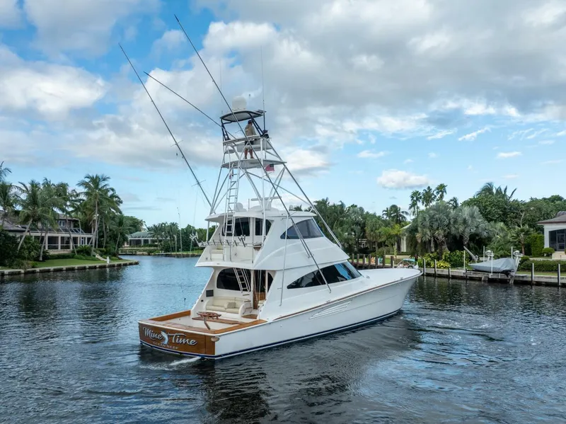 Slide: The Image of 2021 Viking 68 Enclosed Bridge Convertible yacht cruising on a scenic waterway. - 5