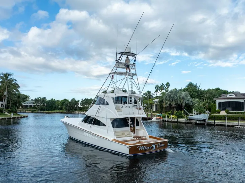 Slide: The Image of 2021 Viking 68 Enclosed Bridge Convertible yacht cruising on a scenic waterway. - 6