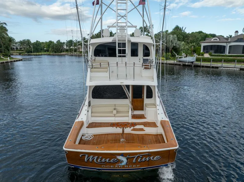 Slide: The Image of 2021 Viking 68 Enclosed Bridge Convertible yacht on a calm waterway. - 9