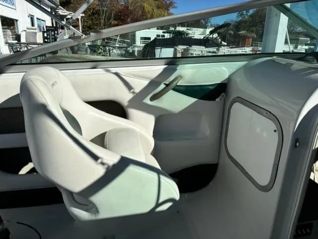 Slide: The Image of Interior of 2002 Crownline 215 CCR boat with white seating and dashboard. - 10