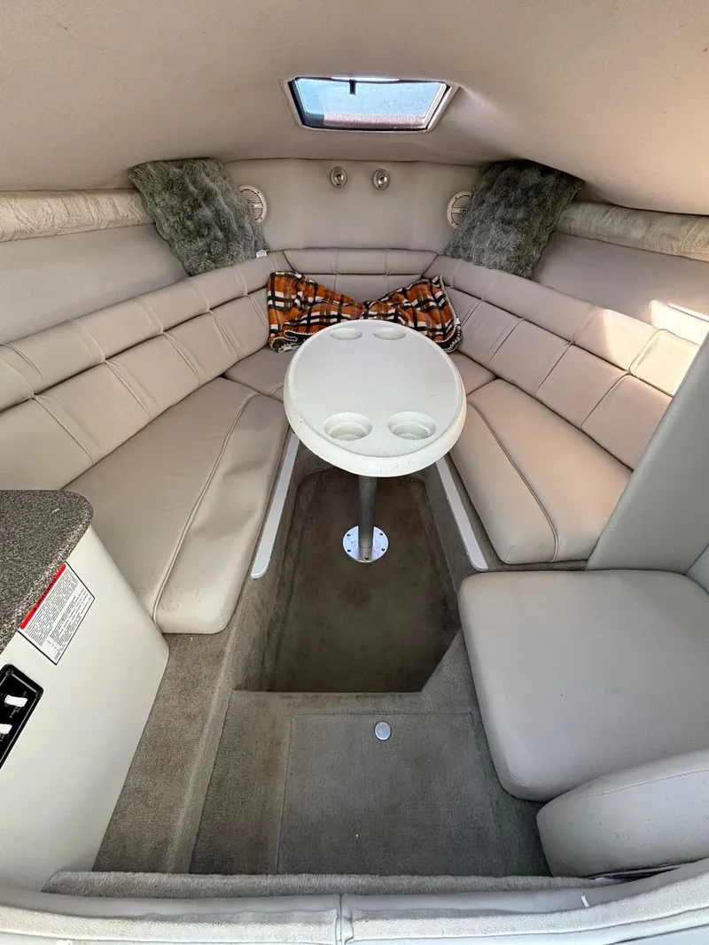Slide: The Image of Interior of 2002 Crownline 215 CCR boat with seating and table. - 17