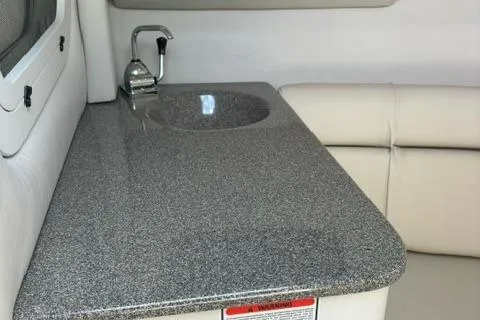 Slide: The Image of 2002 Crownline 215 CCR boat interior with sink and countertop. - 18