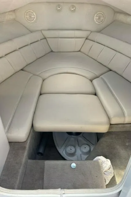 Slide: The Image of 2002 Crownline 215 CCR boat interior with cushioned seating and storage area. - 19