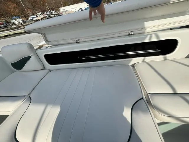 Slide: The Image of 2002 Crownline 215 CCR boat interior with open storage compartment. - 8