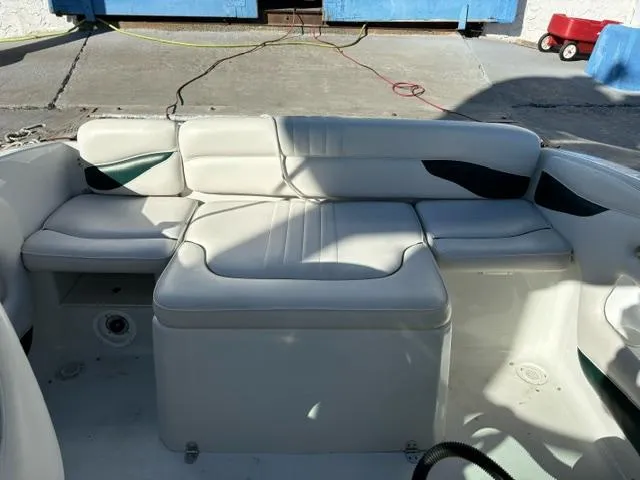Slide: The Image of 2002 Crownline 215 CCR boat interior with white cushioned seating. - 9