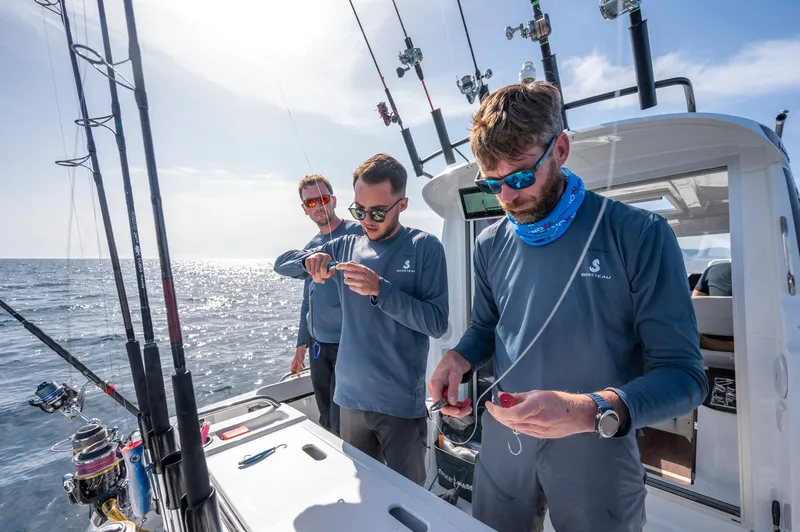 Slide: The Image of Three people fishing on a 2024 Beneteau Antares 8 Fishing boat. - 10