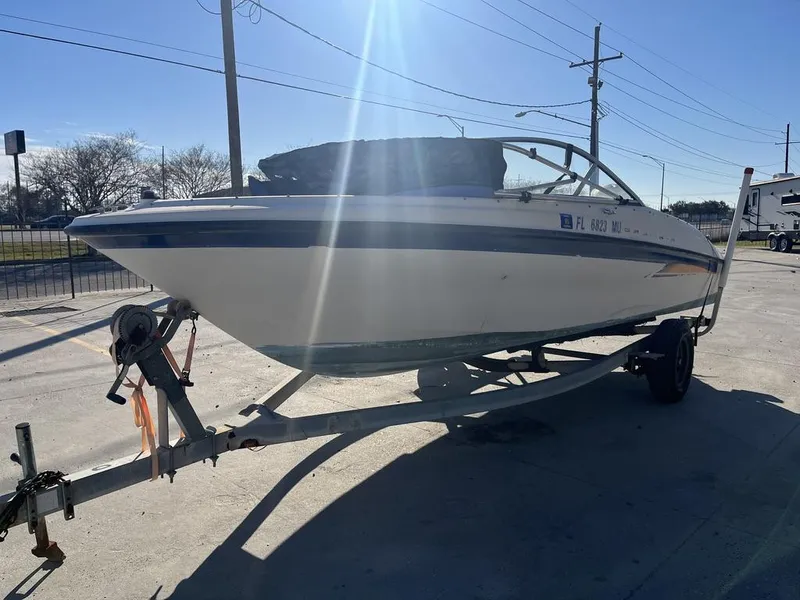 Slide: The Image of 2004 Bayliner 175 boat on trailer in sunny setting. - 12