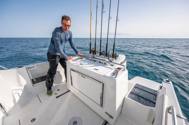 Slide: The Image of Man fishing on 2024 Beneteau Antares 8 Fishing boat, ocean backdrop. - 11
