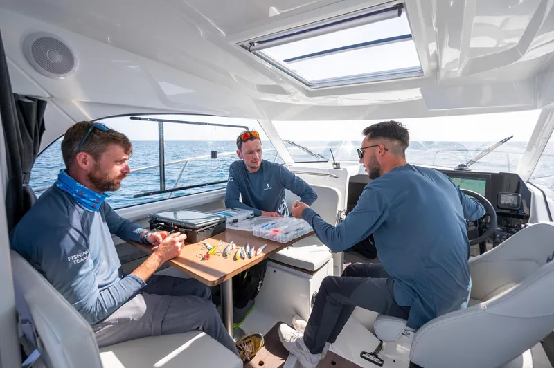 Slide: The Image of Three people fishing on a 2024 Beneteau Antares 8 boat interior. - 8