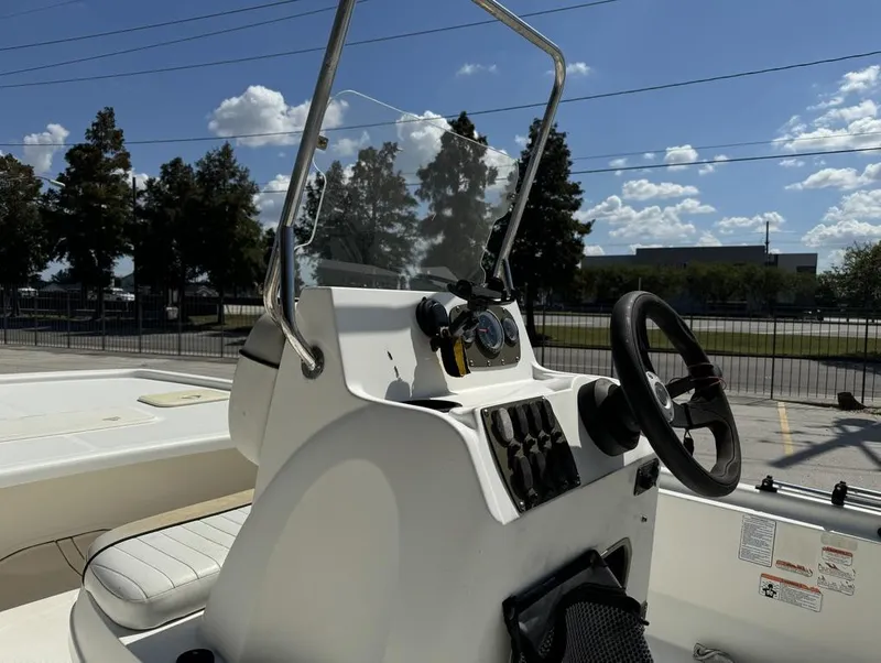 Slide: The Image of 2017 Mako Pro Skiff 19 CC boat console with steering wheel and controls. - 10