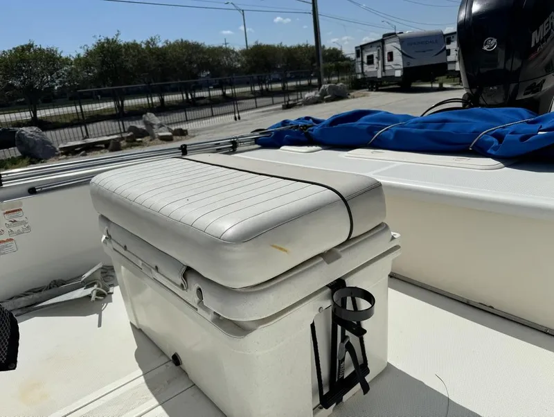 Slide: The Image of 2017 Mako Pro Skiff 19 CC boat interior with cushioned seat and storage. - 11