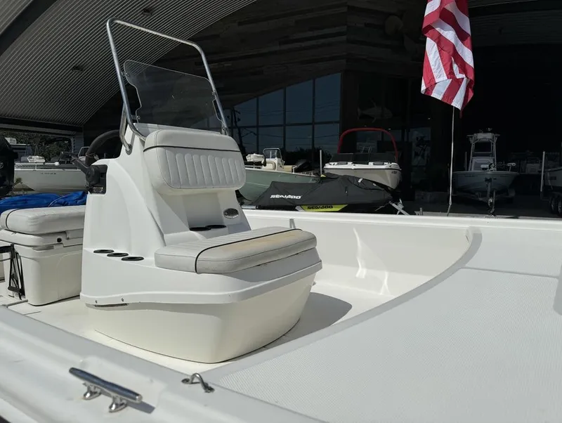 Slide: The Image of 2017 Mako Pro Skiff 19 CC boat interior with seating and American flag. - 13