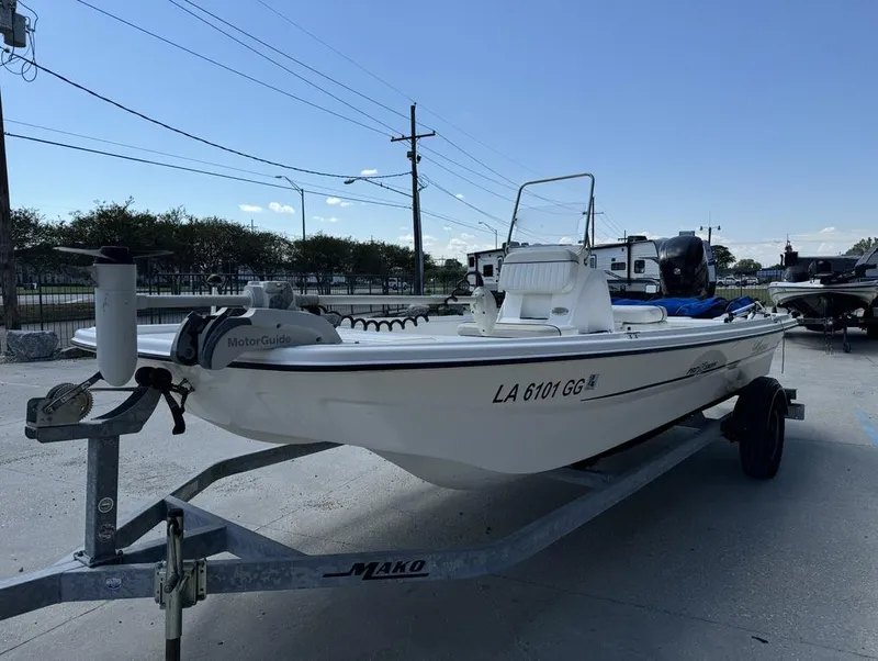 Slide: The Image of 2017 Mako Pro Skiff 19 CC boat on trailer, parked outdoors. - 14