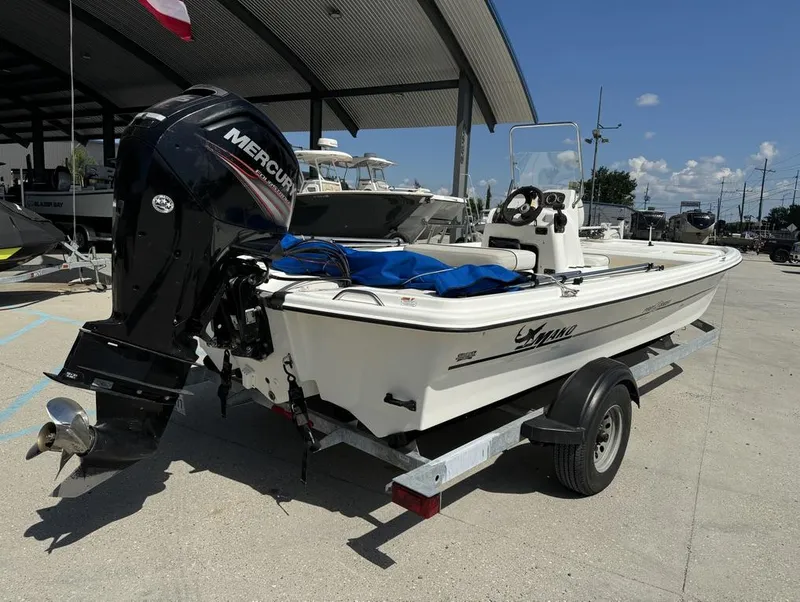 Slide: The Image of 2017 Mako Pro Skiff 19 CC boat with Mercury outboard motor on trailer. - 15