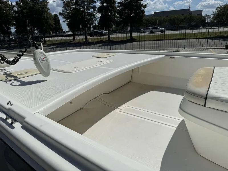 Slide: The Image of 2017 Mako Pro Skiff 19 CC boat interior with seating and storage. - 17