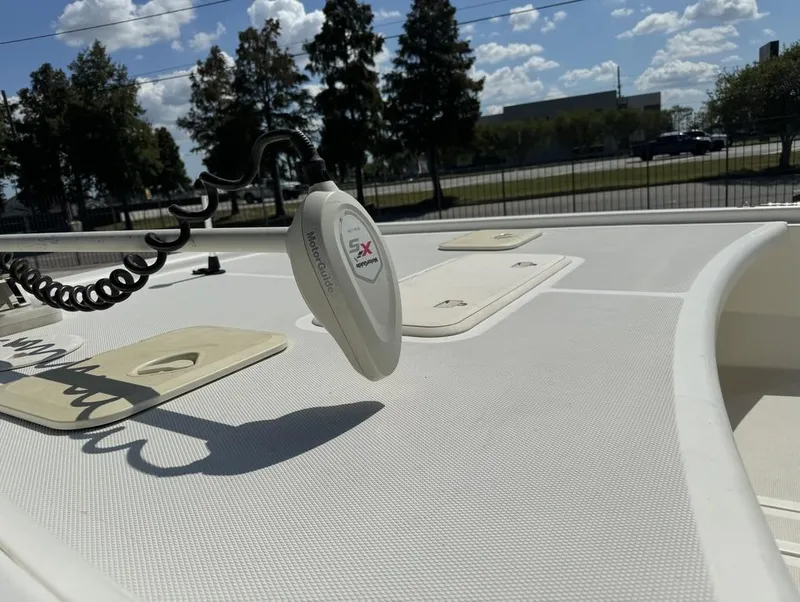 Slide: The Image of 2017 Mako Pro Skiff 19 CC boat deck with trolling motor under sunny sky. - 18