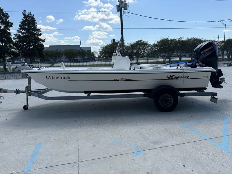 Slide: The Image of 2017 Mako Pro Skiff 19 CC boat on trailer, parked outdoors. - 3