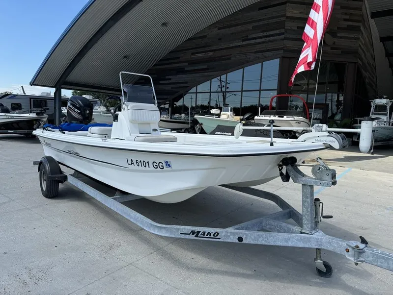 Slide: The Image of 2017 Mako Pro Skiff 19 CC boat on trailer, parked outside dealership. - 5
