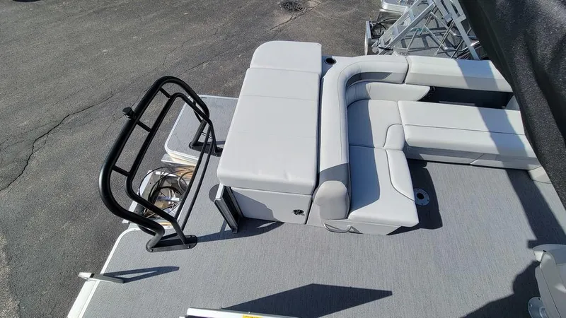 Slide: The Image of 2025 Godfrey Sweetwater 2486 C Sport Tube boat with gray seating and black railing. - 3