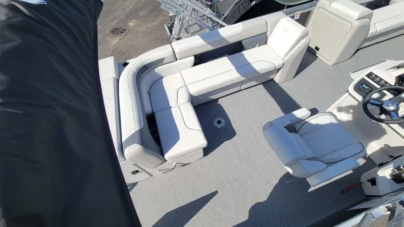 Slide: The Image of 2025 Godfrey Sweetwater 2486 C Sport Tube boat interior with white seating and steering console. - 4