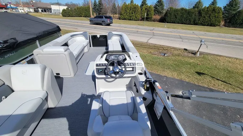 Slide: The Image of 2025 Godfrey Sweetwater 2486 C Sport Tube boat interior with steering console and seating. - 7
