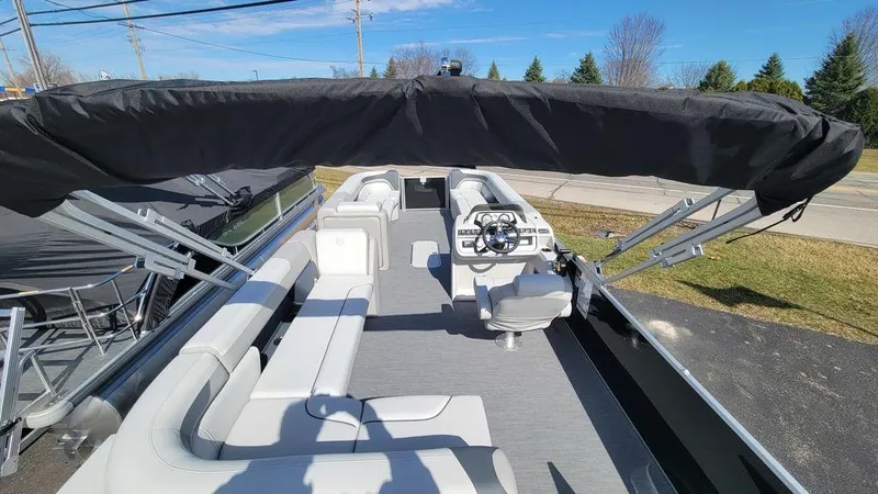 Slide: The Image of 2025 Godfrey Sweetwater 2486 C Sport Tube pontoon boat with spacious seating and modern helm. - 8