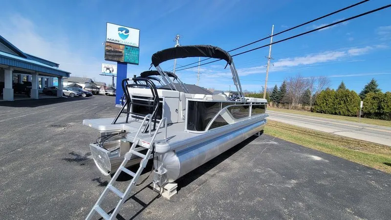 Slide: The Image of 2025 Godfrey Sweetwater 2486 C Sport Tube pontoon boat displayed outdoors. - 9