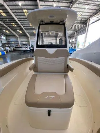 Slide: The Image of 2025 Scout 260 LXF boat interior with seating, in a spacious indoor marina. - 13
