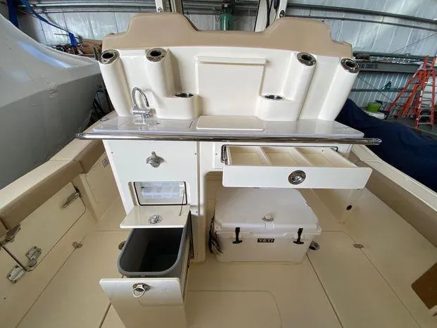 Slide: The Image of 2025 Scout 260 LXF boat interior with storage compartments and sink. - 17