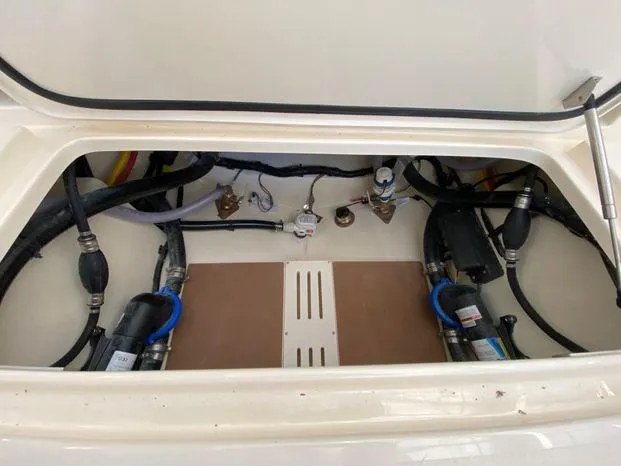 Slide: The Image of 2025 Scout 260 LXF boat compartment with visible wiring and components. - 19