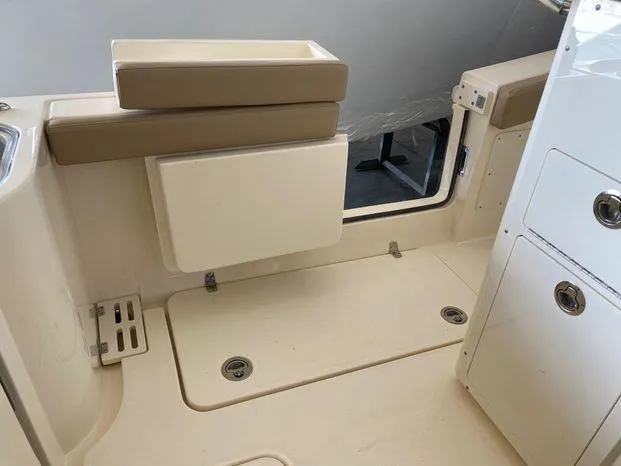 Slide: The Image of Interior of 2025 Scout 260 LXF boat, featuring storage compartments and seating area. - 20