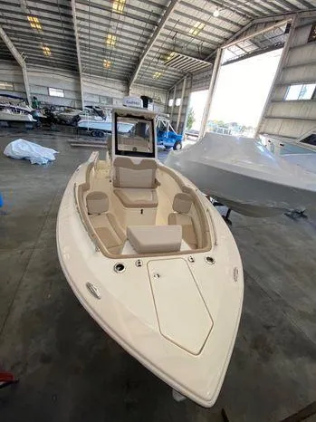 Slide: The Image of 2025 Scout 260 LXF boat in a spacious indoor marina. - 5