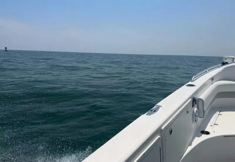 Slide: The Image of 2007 Scarab 35 Tournament boat on open sea, clear sky, calm waters. - 2