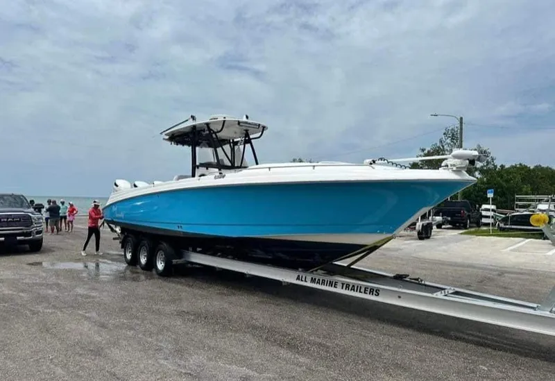Slide: The Image of 2007 Scarab 35 Tournament boat on trailer, blue hull, parked at marina. - 5