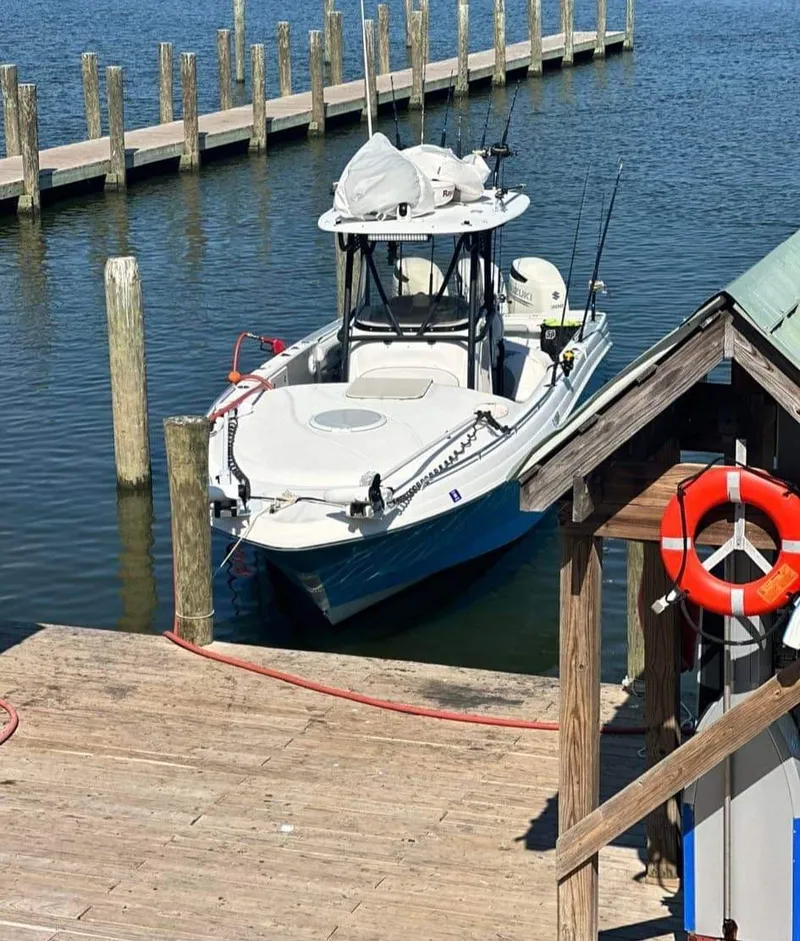 Slide: The Image of 2007 Scarab 35 Tournament boat docked at a marina with fishing gear. - 6