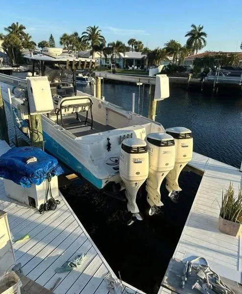 Slide: The Image of 2007 Scarab 35 Tournament boat with triple outboard engines docked by the water. - 8
