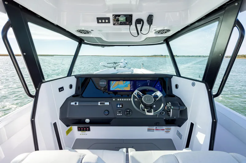 Slide: The Image of Interior view of 2025 Axopar 29 CCX boat cockpit with modern navigation system. - 11