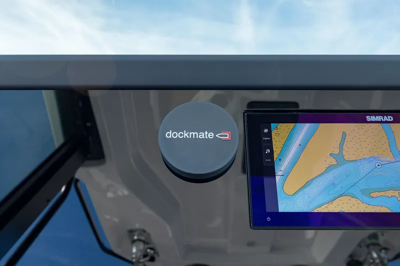 Slide: The Image of 2025 Axopar 29 CCX dashboard with Dockmate and Simrad navigation display. - 13
