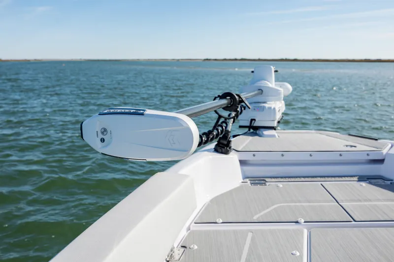 Slide: The Image of 2025 Axopar 29 CCX boat with advanced trolling motor on open water. - 16