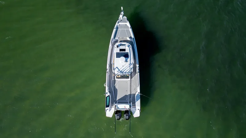 Slide: The Image of Aerial view of 2025 Axopar 29 CCX boat on green water. - 2