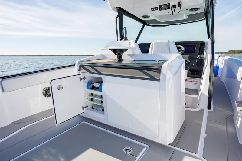 Slide: The Image of 2025 Axopar 29 CCX boat interior with open storage, sleek design, and modern controls. - 24